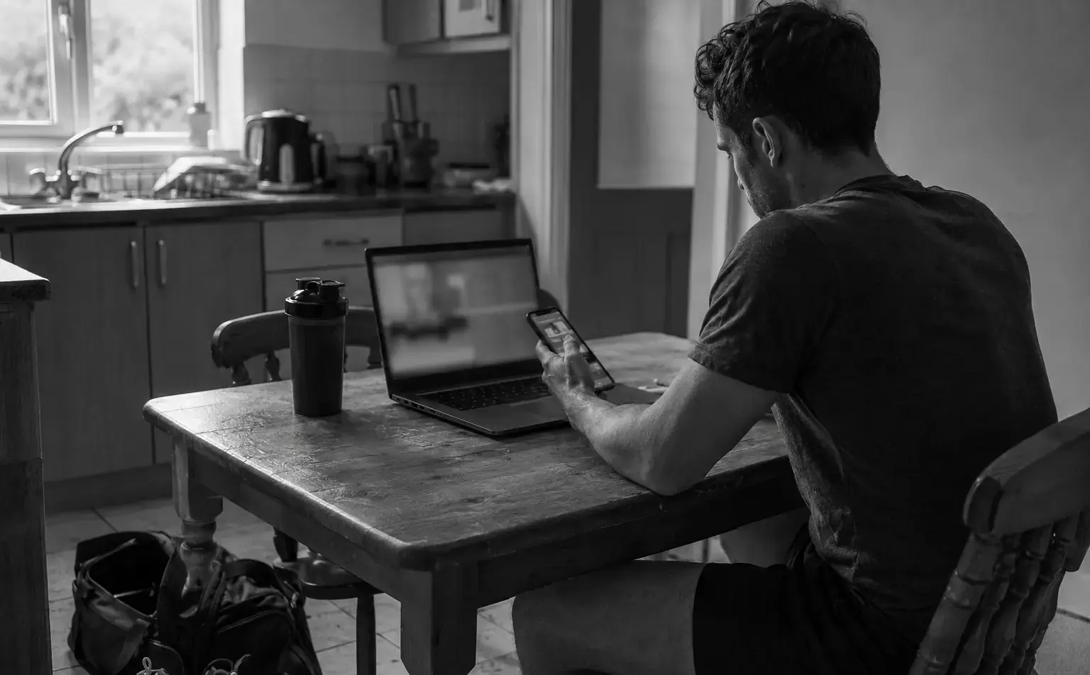 A lifter reviewing a training programme and lift footage at home